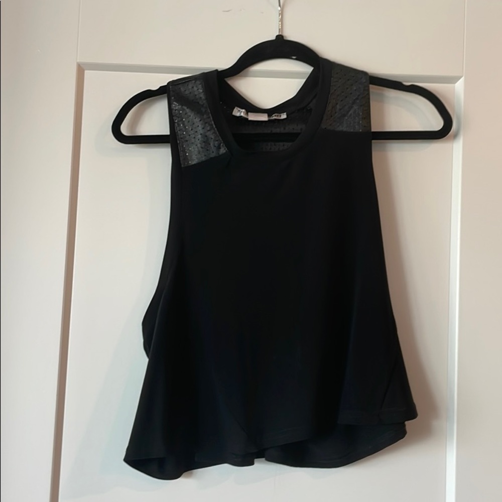Black crop top with leather embroidery; low back